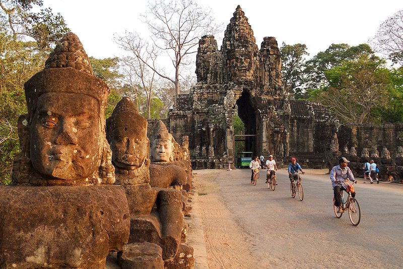 Cyclistes à la Porte Sud d'Angkor Thom - Site archéologique d'Angkor - Cambodge